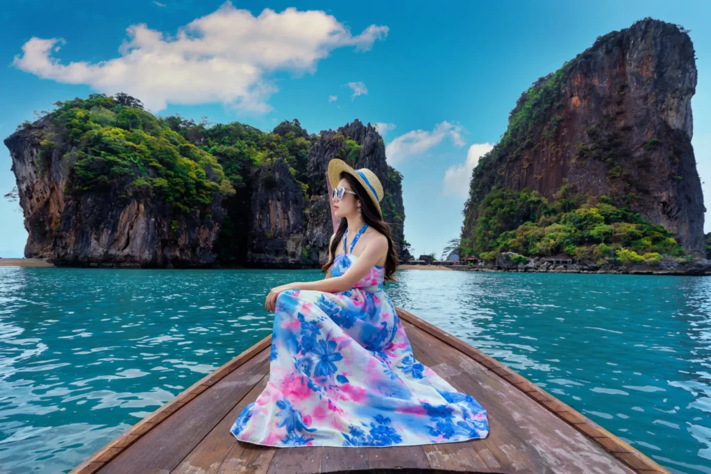 beautiful girl sitting boat james bond island phang nga thailand Horizontal